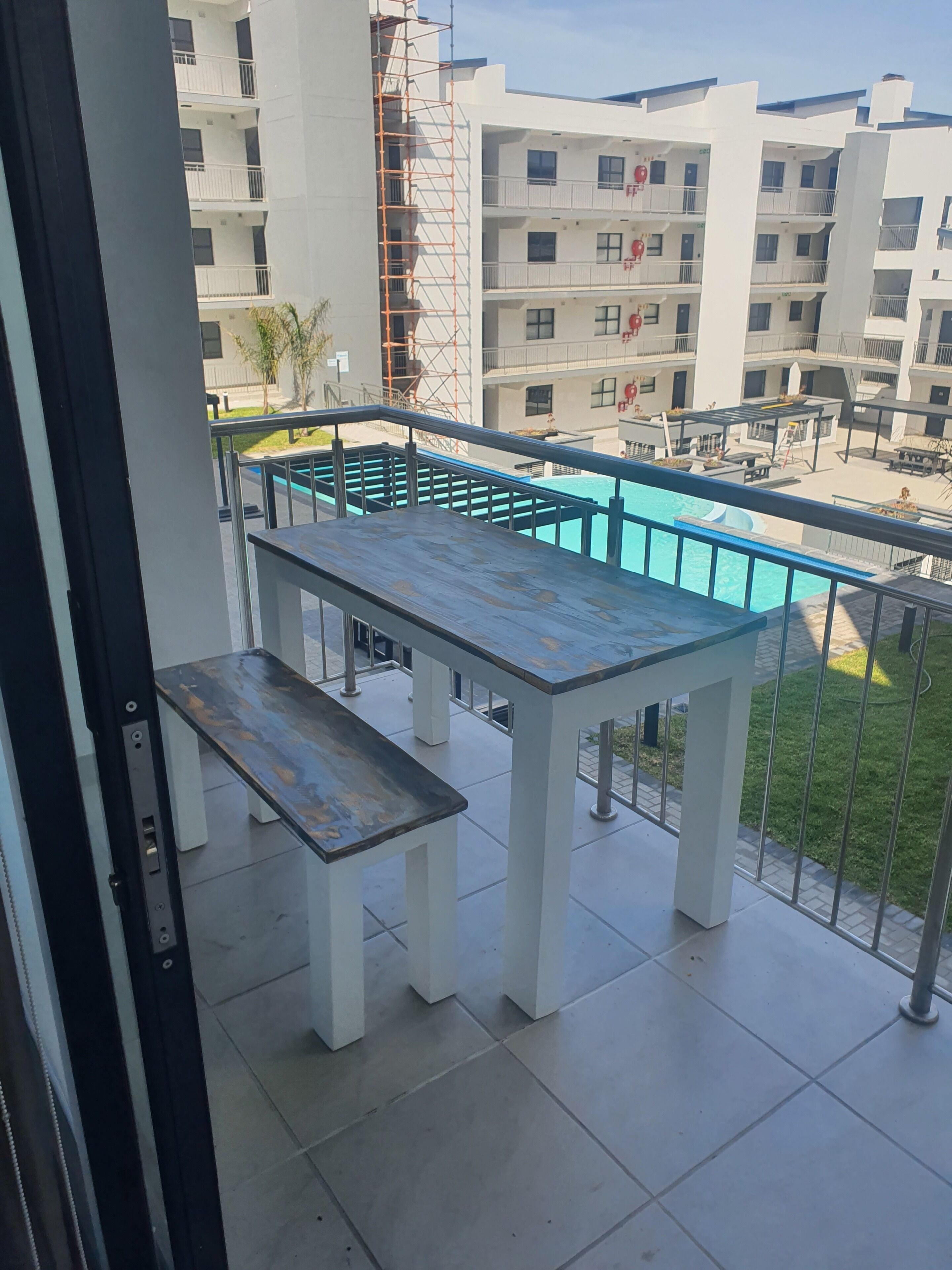 A balcony with a pool table and a pool.