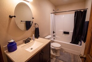 A bathroom with a sink, toilet, and bathtub. - Ennis Montana Cabin - Madison Range Views - 5 minutes to the Madison River (Ennis)