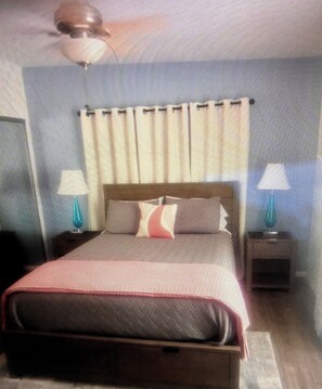 A bedroom with a bed, curtains, a nightstand, and a lamp. - Marvelous 3-bedroom house in sunny Palm Springs (Palm Springs)