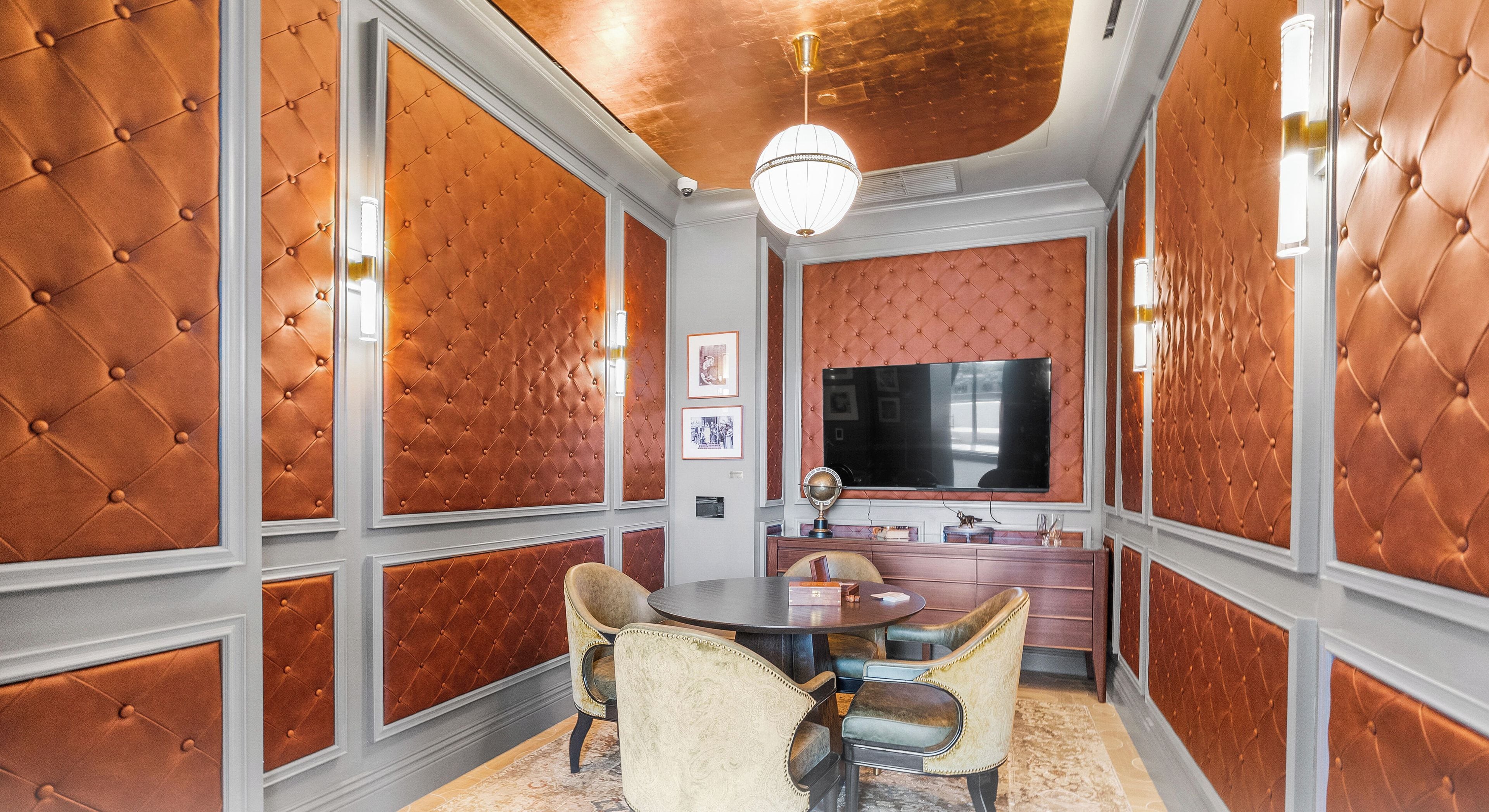 A conference room with a round table, chairs, a television, and a decorative globe.