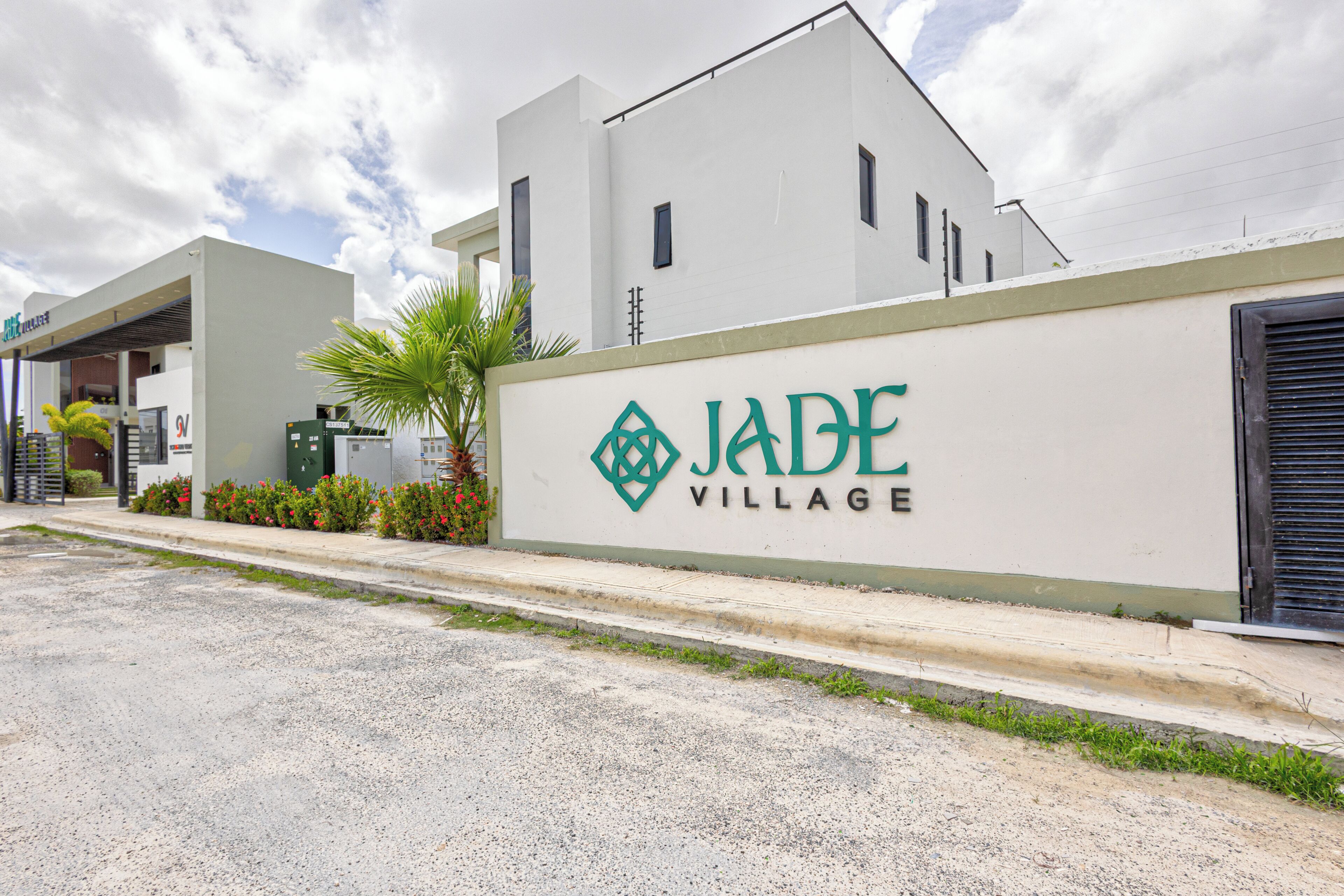A modern building with a sign reading 'JADE VILLAGE'.