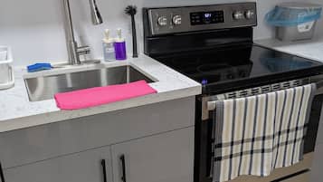 A modern kitchen with stainless steel appliances, a sink, and a countertop.
