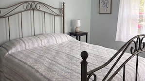 A bedroom with a bed, a bedside table, a lamp, a window with curtains, and a ceiling fan. - 3 Bedroom Argyle Mermaid by the sea (Neptune Township)