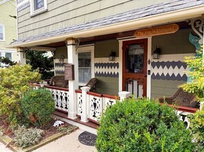 A house with a porch, a sign reading 'The Argyle Mermaid,' and a decorative fence. - 3 Bedroom Argyle Mermaid by the sea (Neptune Township)