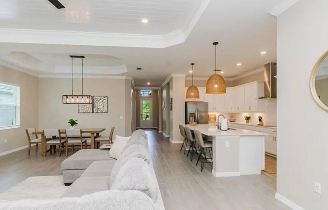 A modern interior with a dining area, kitchen, and living space.