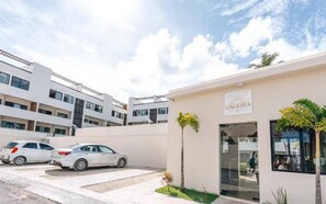 A modern building with a sign reading 'GALERIA' and a parking area with two white cars. - A magnificent oasis of peace just a few minutes from Bavaro Beach (Punta Cana)