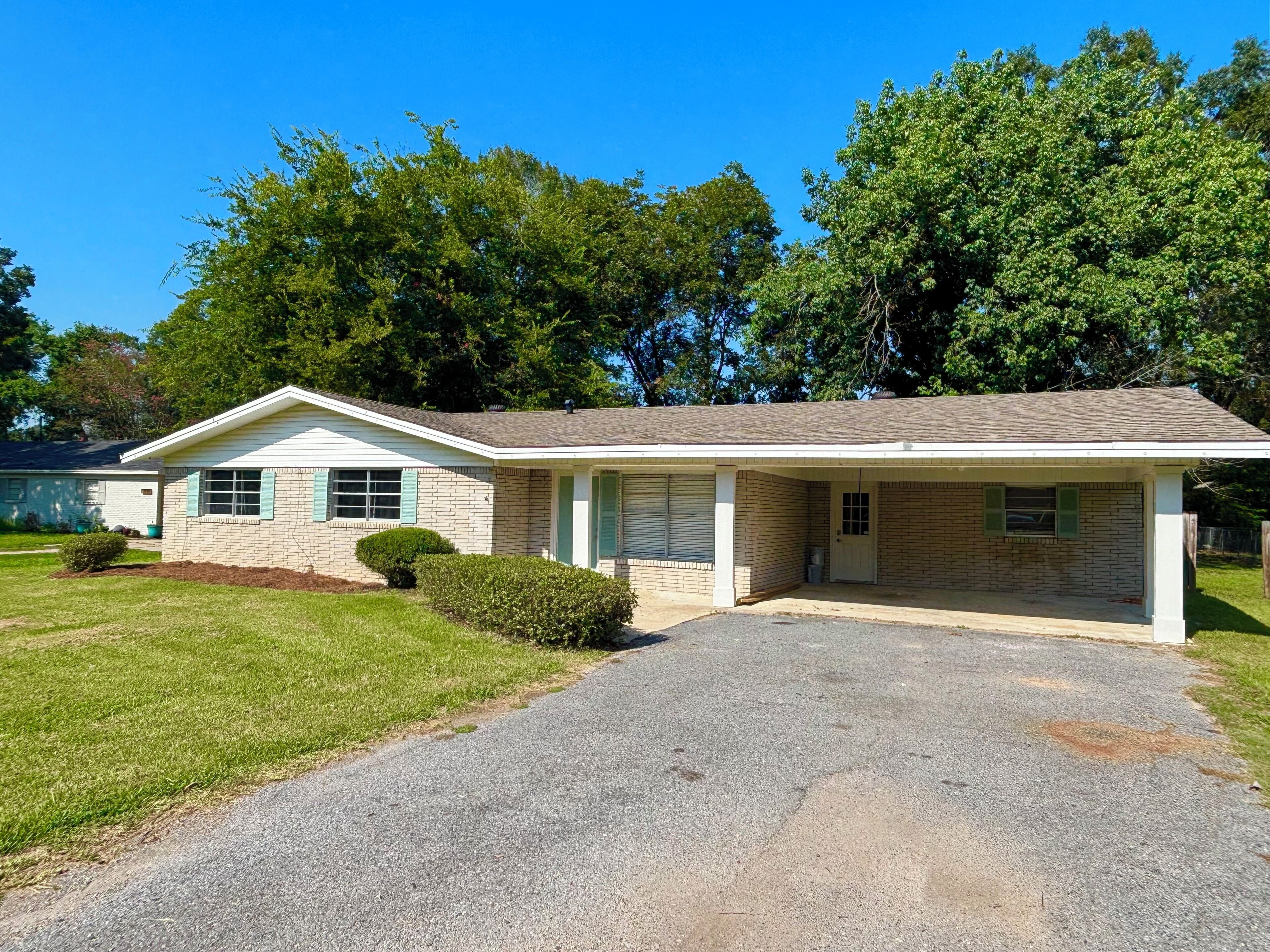 A single-story house with a front garage, a covered porch, and a well-maintained lawn.