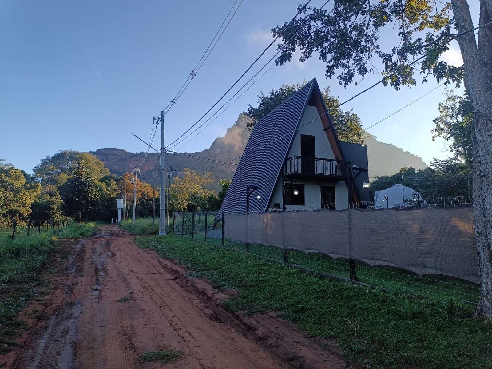 A house with a sloped roof and a fenced yard.