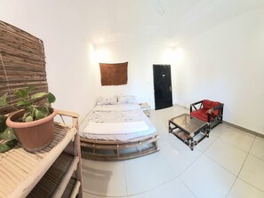 A room with a bed, a chair, a potted plant, and a wall-mounted towel. - Room-beautiful Private Room With Private (Bamako)