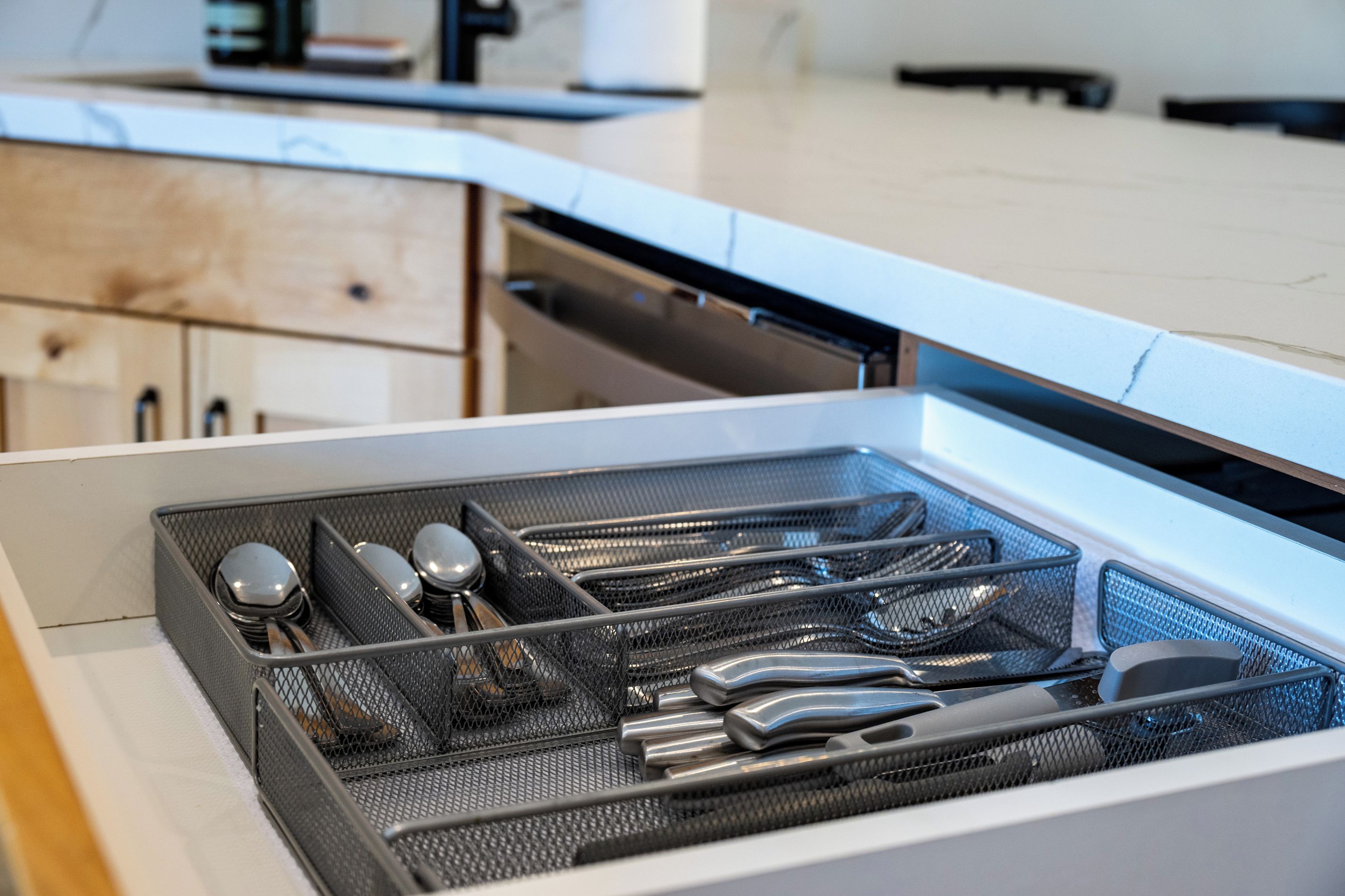A kitchen drawer with utensils.
