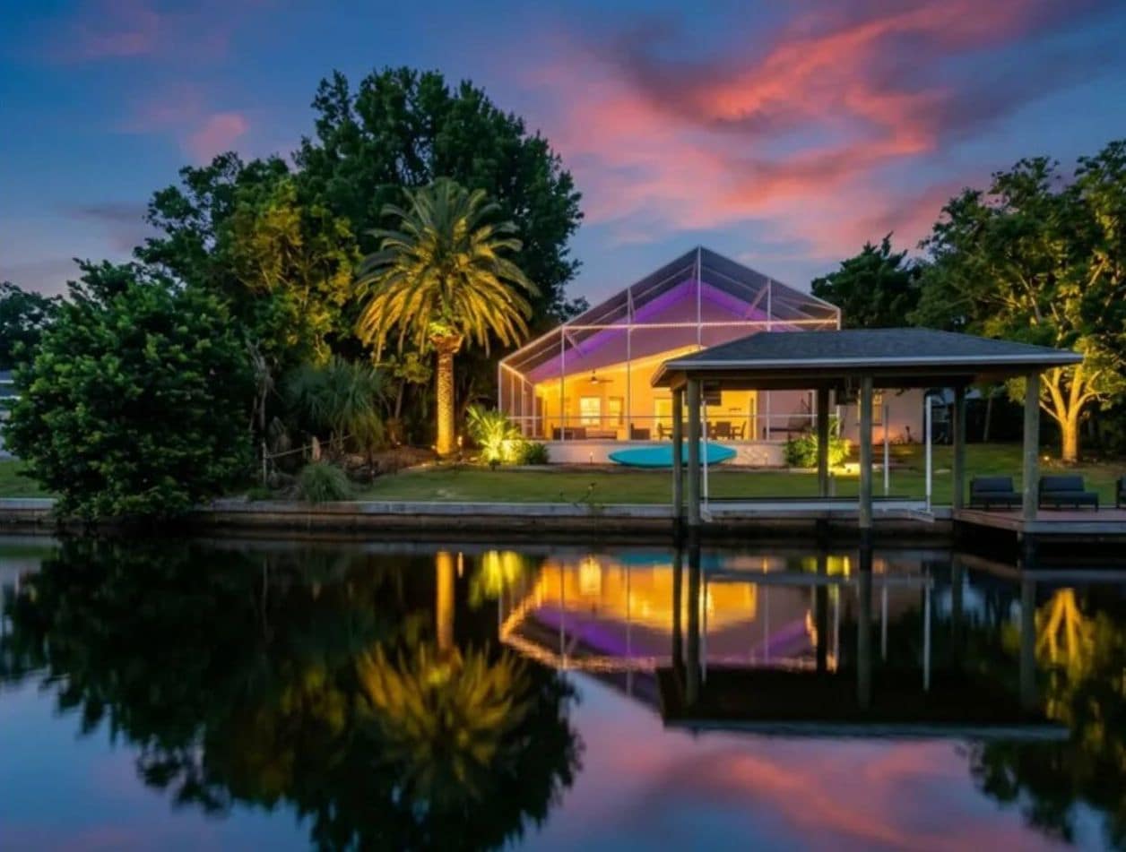 Waterfront oasis with private dock, screened pool, and stunning sunset views