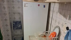 A kitchen with a sink, a refrigerator, and a ladder. - Apartamento Simples mas Completo Centro Histórico Área Tranquila (Porto Alegre)