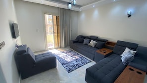 A modern living room with a sofa set, a coffee table, and a patterned rug. - Luxurious Apartment - Gardenia Nasr City (Cairo)