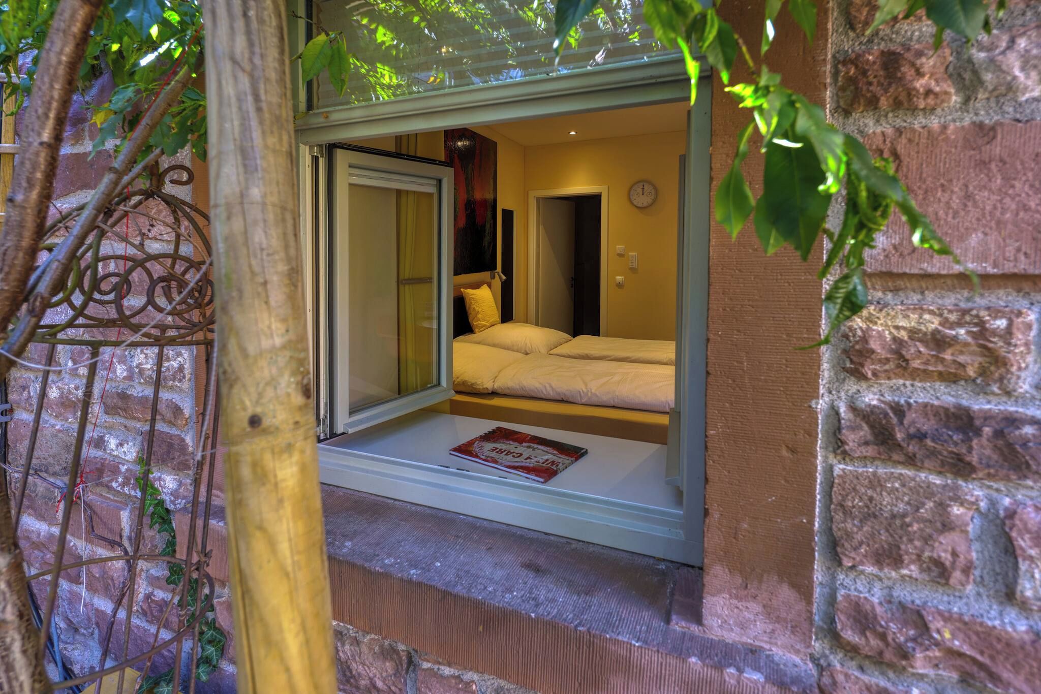 A room with a bed, a window, and a door.