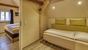A bedroom with a bed, a bedside table, and a window. - Maisonette Apartment The Haystack Ad1716 (Marktheidenfeld)