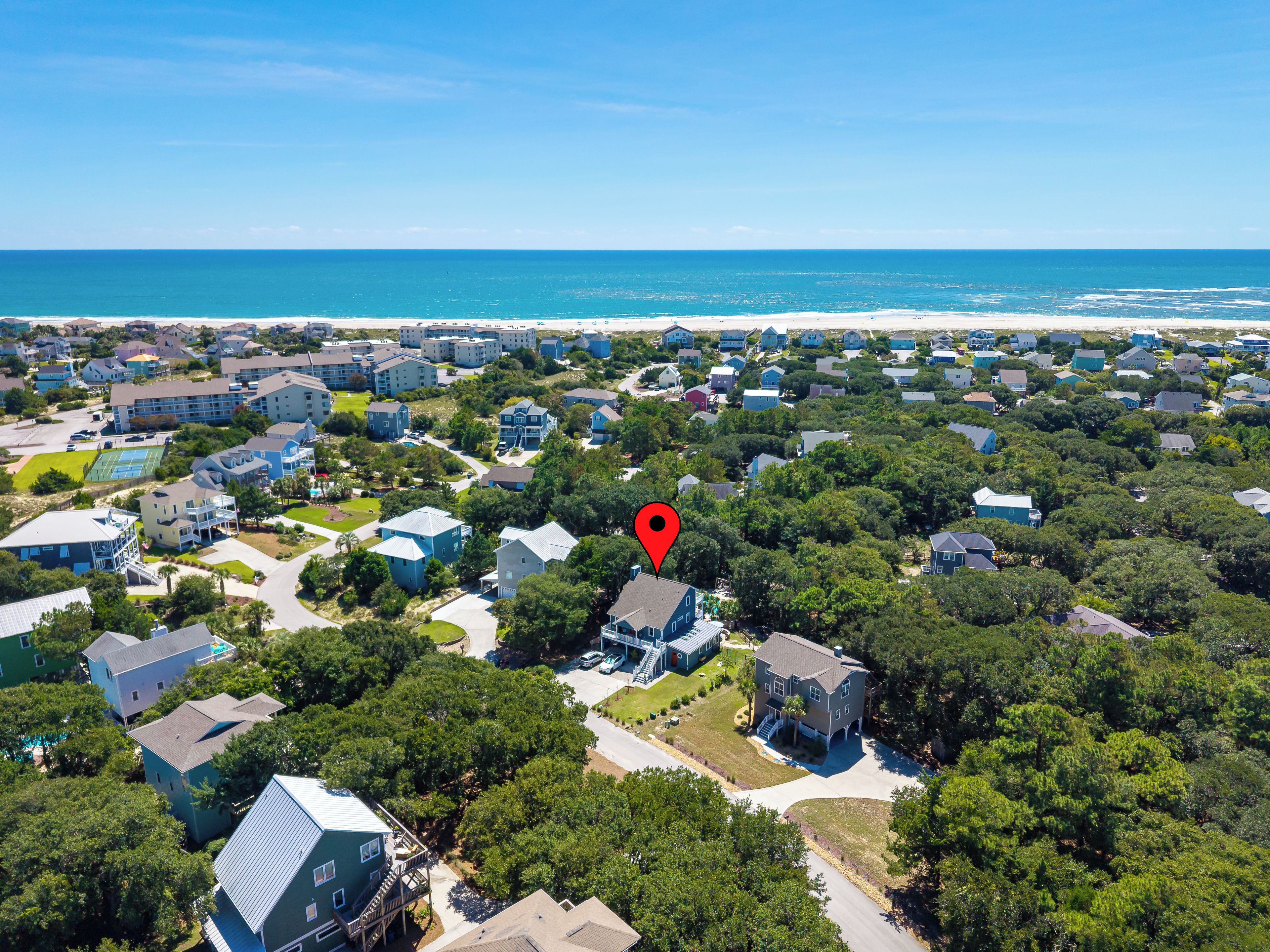 A residential area with houses, a beach, and a golf course.