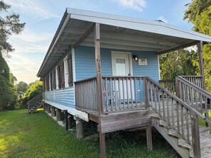 Ein zweistöckiges Holzhaus mit Veranda, Briefkasten und Hausnummer.