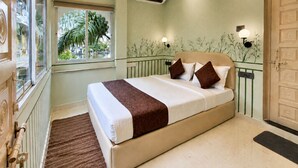 A bedroom with a bed, a window, an air conditioning unit, and a door. - White Nest Stays - Udaipur (Udaipur)