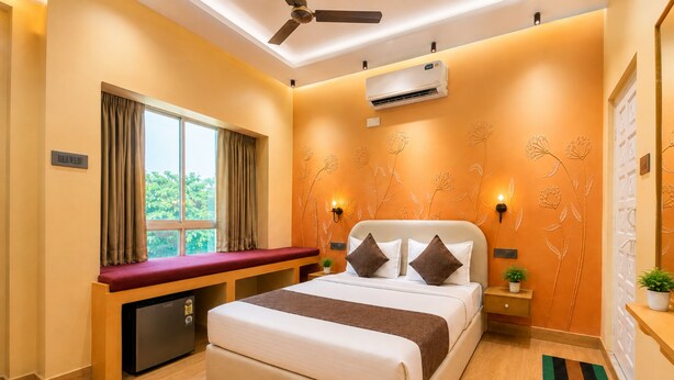 A hotel room with a bed, a desk, a window with curtains, an air conditioner, and a ceiling fan. - White Nest Stays - Udaipur (Udaipur)
