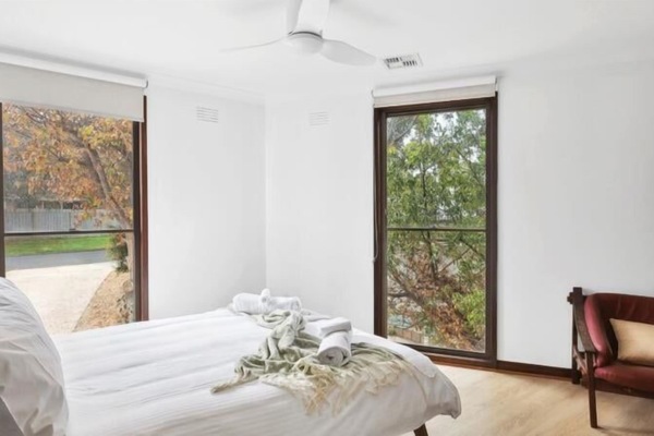 Light-filled bedroom with leafy outlooks.