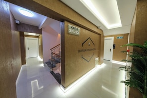 A hotel corridor with a sign for 'KAT 3 301-306' and 'BURSA KONAK HOTEL' branding.