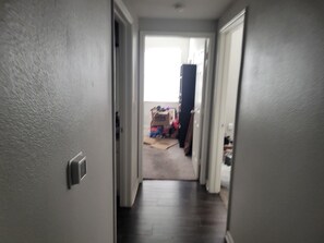 A hallway leading to a room with a visible door and a window. - Spacious 3-bedroom apartment with AC in beautiful Austin (Austin)