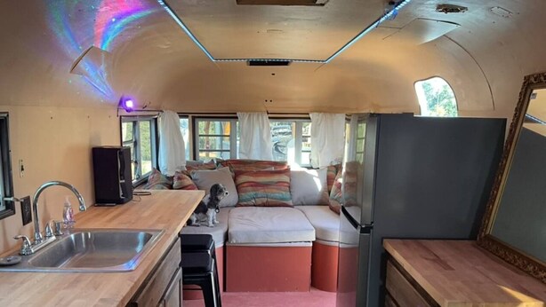A compact kitchen with a sink, countertop, and a refrigerator. - Moonshadow Flat Glamping: Gypsum Tent (Penn Valley)