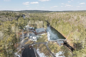 A cabin with a dock extending into a river, surrounded by dense forest. - Spacious 4-bedroom house in fabulous Sparrow Bush with AC (Sparrow Bush)