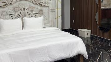 A modern bedroom with a marble floor, a white bed with a decorative headboard, and a geometric patterned wall.