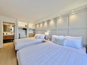 A hotel room with two beds, a bathroom with a mirror, and a wardrobe. - 29F-Upscale-Fully Renovated-Waikiki Banyan 1 Bedroom-Ocean View w/ Free Parking (Honolulu)