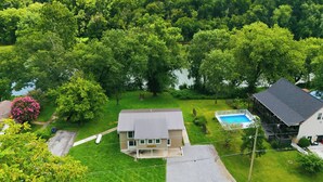 A residential area with a house, a swimming pool, and a large green park. - River Bend Reserve (Frankfort)
