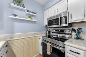 A kitchen with white cabinets, a microwave, an oven, and a toaster. - Pretty Peacock 2BD 2Bath - 1 mile to Silver Dollar City, Branson West (Branson West)