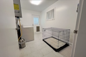 A room with a white door, a metal cage, and a utility meter on the wall. - Cozy family/pet friendly, 3 BDR pool home, 20 mins from downtown Atlanta. (Atlanta)
