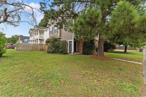 A two-story house with a front porch, a brick entrance, and a well-maintained lawn. - 2BR Home Near Augusta National & Medical District (Augusta)