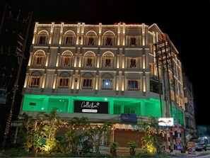 A multi-story building with a sign reading 'Collection' and a 'Company-Served' logo. - Classic Iubit Hotel (Kolkata)