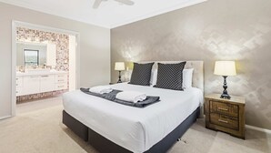A hotel room with a bed, two bedside tables, a nightstand, a ceiling fan, and a bathroom with a tiled shower area. - The Ritz, Family Pool Home, Dubbo (Dubbo)