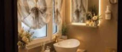 A bathroom with a large mirror, a vessel sink, and a toilet.