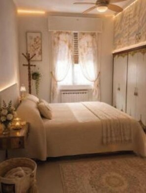 A bedroom with a bed, a nightstand, a radiator, and a window with curtains.