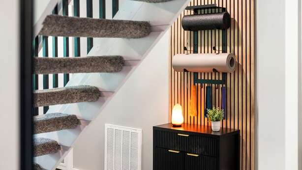 A staircase with a unique design, a wall-mounted heater, and a small plant on a cabinet. - Secluded Luxury Escape, Hot Tub, Fire Pit, Game Room & Yoga, Walk to Town (Woodstock)