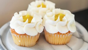 Three cupcakes with white frosting and a yellow filling on a marble surface. - Secluded Luxury Escape, Hot Tub, Fire Pit, Game Room & Yoga, Walk to Town (Woodstock)