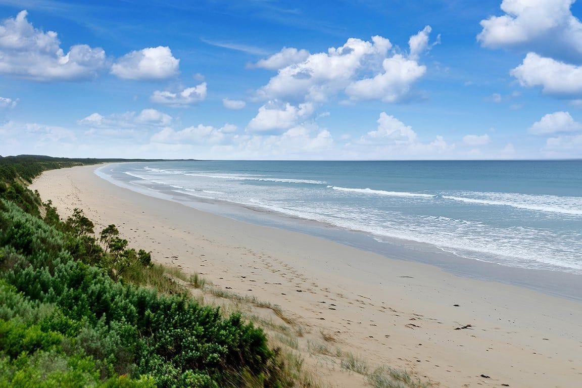 A beach with a clear sky and gentle waves.