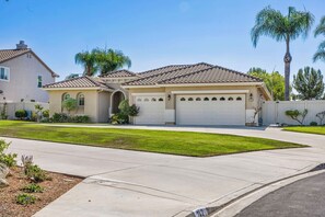 A two-story house with a tiled roof, a garage, and a well-maintained lawn. - Welcome to Casa de Las Mariposas! Single Story, 3 Bed, 3 Bath, Fire Pit & Views! (San Marcos)