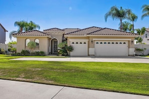 A two-story house with a tiled roof, a garage, and a well-maintained lawn. - Welcome to Casa de Las Mariposas! Single Story, 3 Bed, 3 Bath, Fire Pit & Views! (San Marcos)