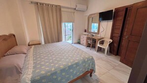 A bedroom with a bed, a desk, a chair, a television, and a wardrobe. - For rent in one of Manzanillo's most well-equipped and sought-after condominium complexes. (Manzanillo)