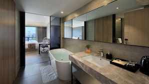 A modern bathroom with a bathtub, a sink, and a large mirror. - (Shenzhen)