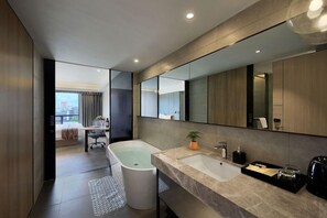 A modern bathroom with a bathtub, a sink, and a large mirror. - (Shenzhen)