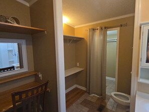 A bathroom with a toilet, a shower curtain, and a window. - Cozy 3 bedroom house in beautiful Raeford with AC and an office. (Raeford)
