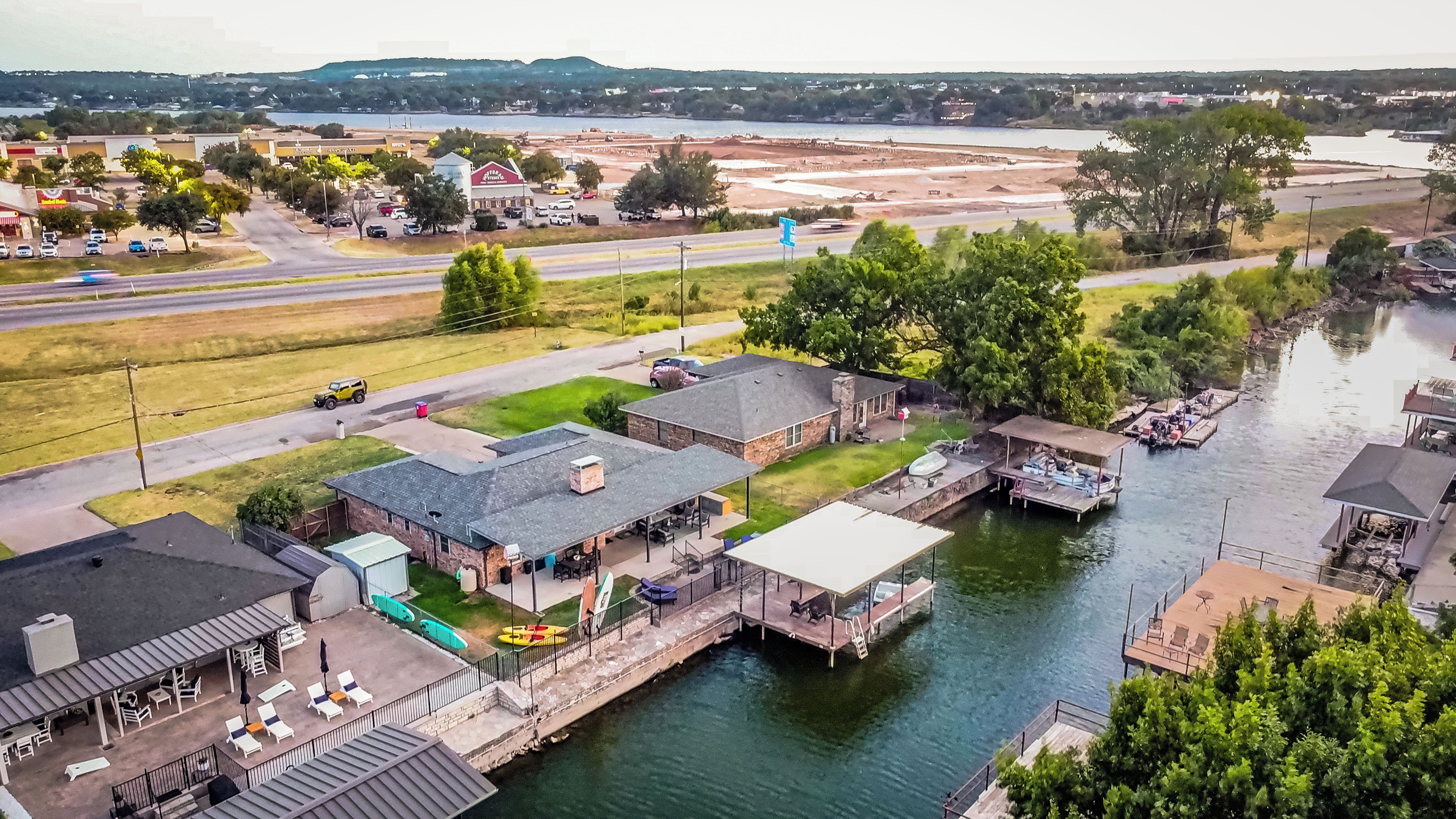 A riverside property with a dock, outdoor seating, and a view of the water.