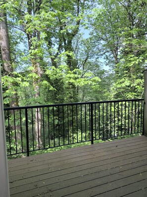 A wooden deck with a black railing overlooking a forested area. - 2 Bed 2.5 Bath Townhome with En-Suite bathrooms (Oregon City)