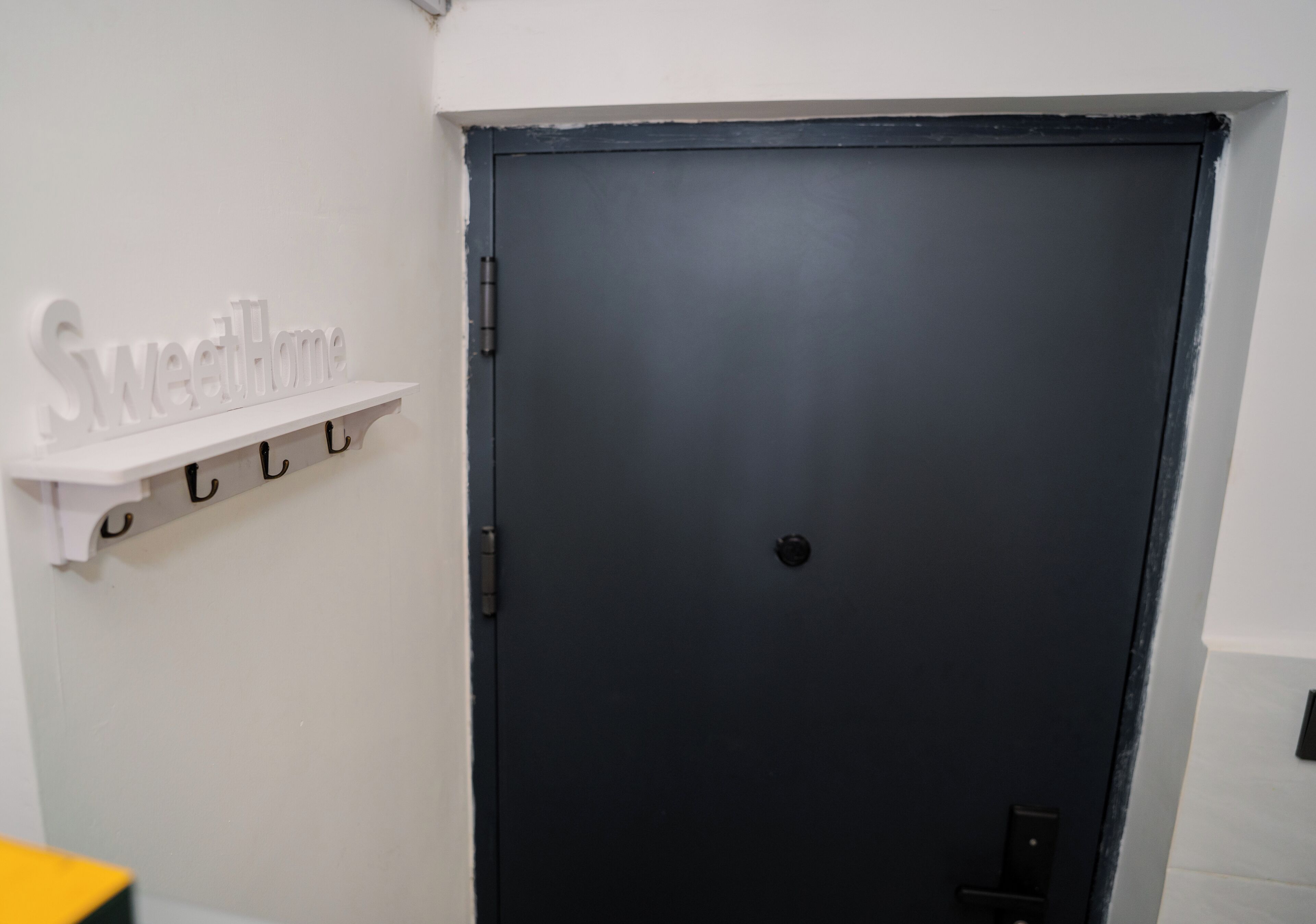 A closed door with a black handle and a small circular lock.